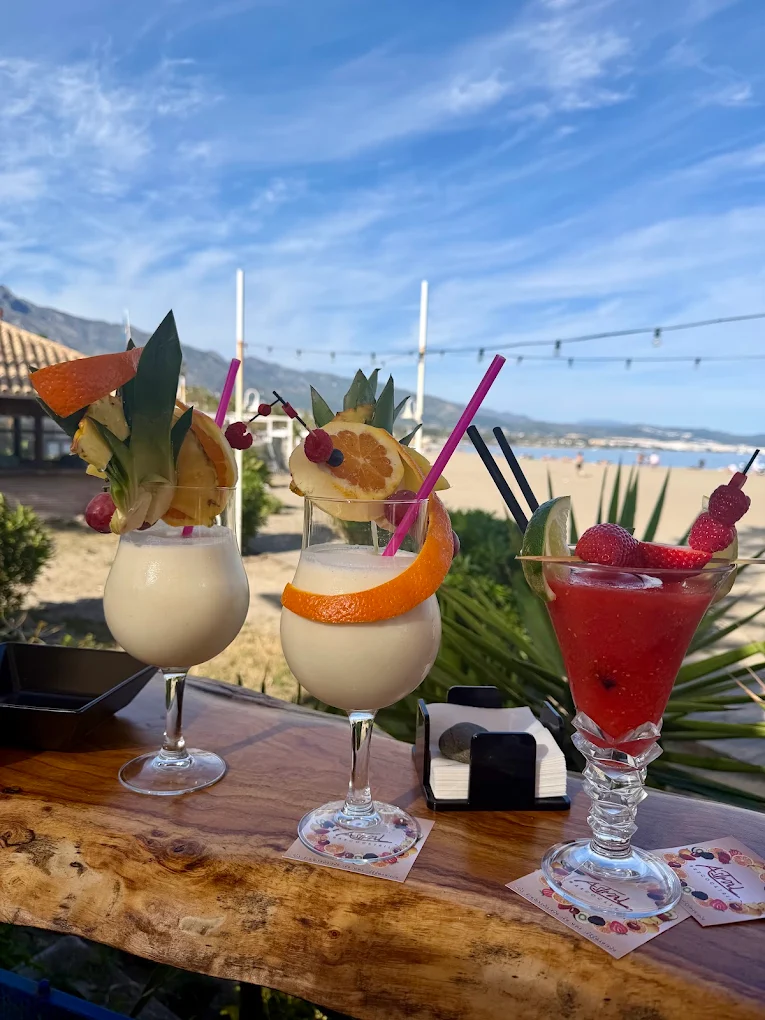 Cocktails at Astral Bar with the beach behind
